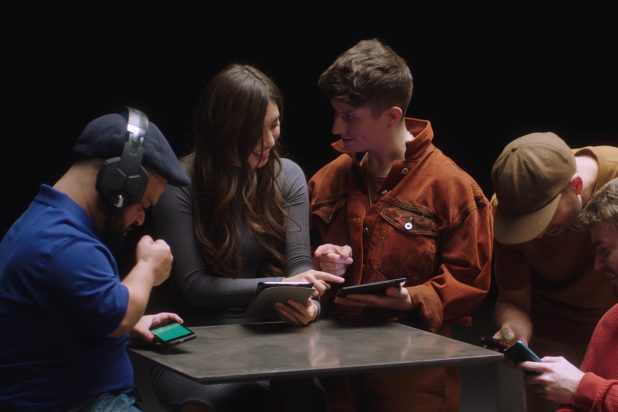 Group of people looking at their mobile devices and tables