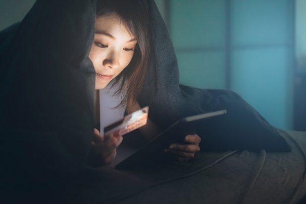 Woman paying with credit card on a tablet