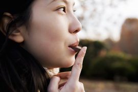 Woman eating a bar of chocolate