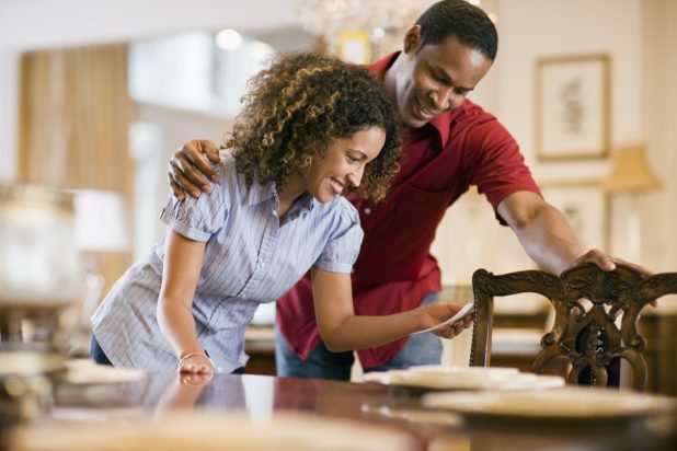 Couple looking at a prize tag for a chair