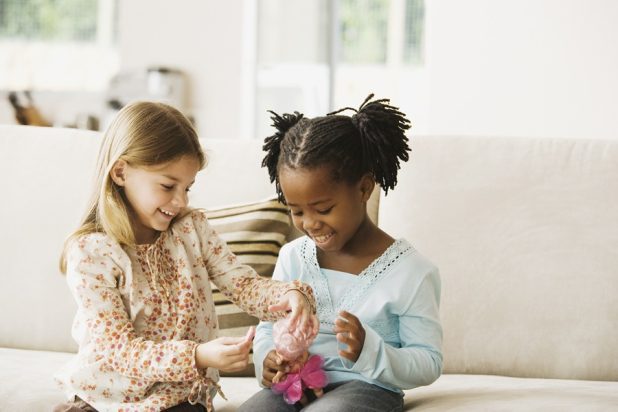 Children playing with a toy doll